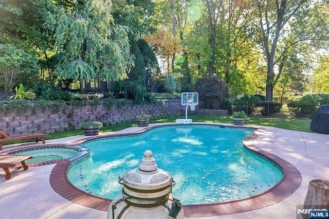 view of swimming pool with a patio area and an in ground hot tub