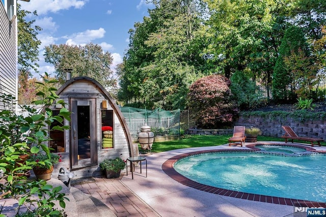 view of pool featuring an in ground hot tub and a patio