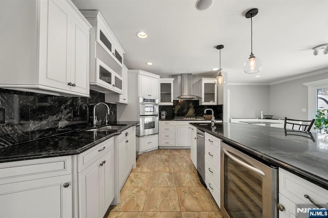 kitchen featuring white cabinetry, wall chimney range hood, and wine cooler