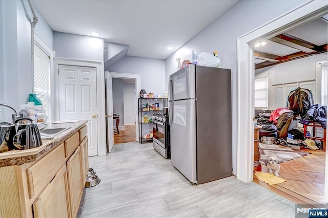 kitchen featuring stainless steel appliances and light brown cabinets