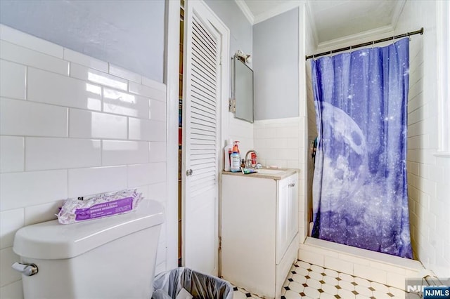 bathroom featuring ornamental molding, toilet, tile walls, and vanity