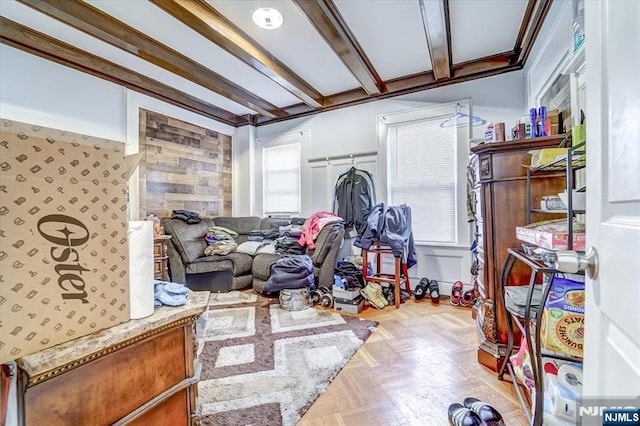 interior space with beamed ceiling, light parquet flooring, and plenty of natural light