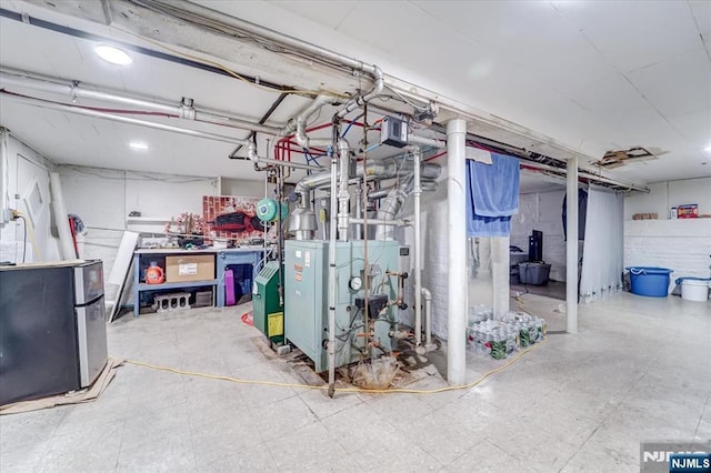 basement featuring stainless steel refrigerator