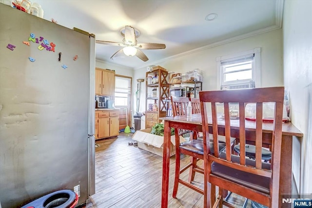 dining room featuring ornamental molding, ceiling fan, and light hardwood / wood-style flooring