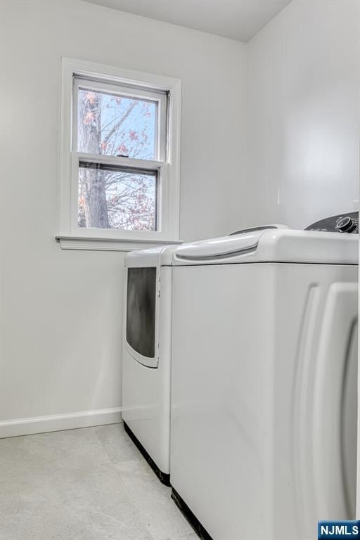 clothes washing area with washing machine and clothes dryer