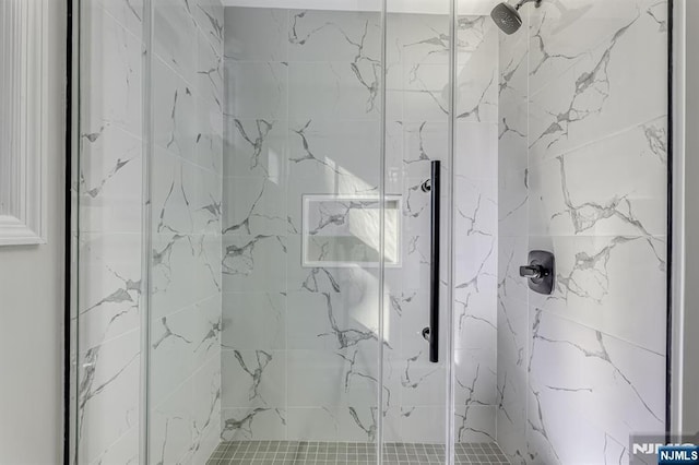 bathroom featuring a shower with shower door