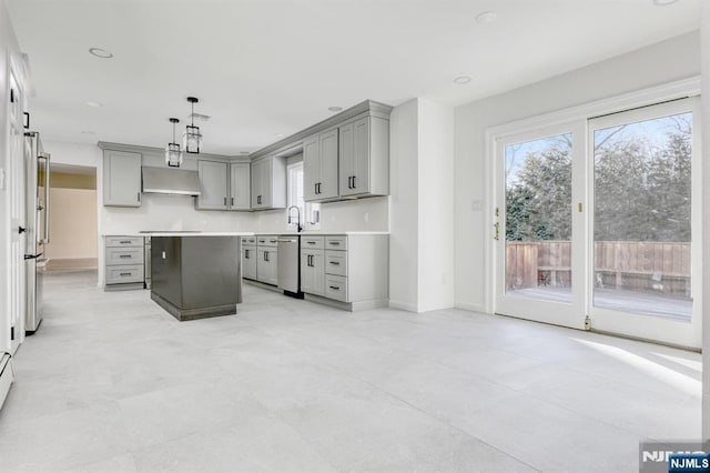 kitchen with a kitchen island, pendant lighting, sink, gray cabinetry, and stainless steel dishwasher