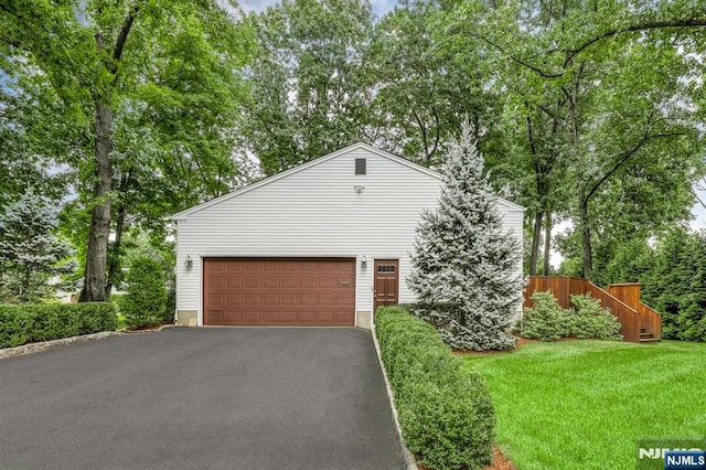 view of front of home featuring a garage and a front lawn