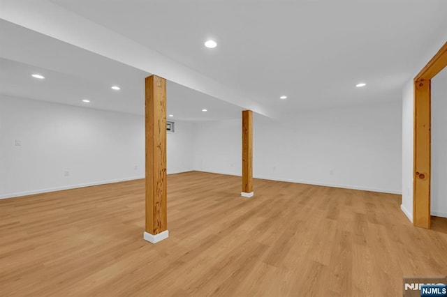 basement with light hardwood / wood-style flooring