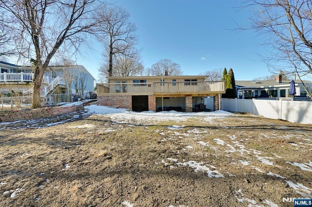 snow covered property with a wooden deck