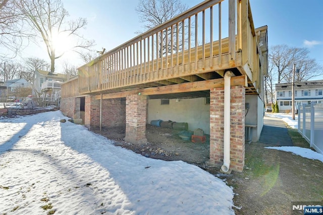 view of snow covered exterior featuring a deck