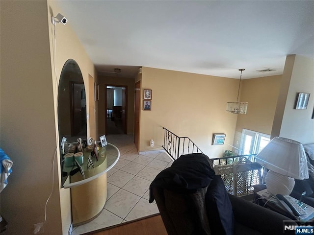 tiled living room featuring a chandelier