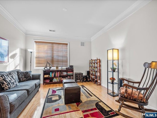 living room with crown molding and light wood-type flooring