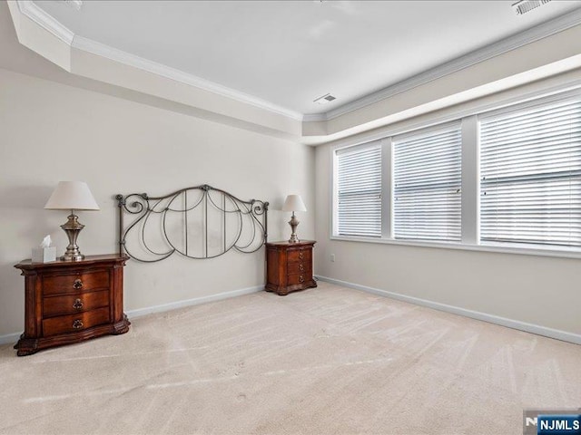 bedroom featuring a raised ceiling, crown molding, and light colored carpet