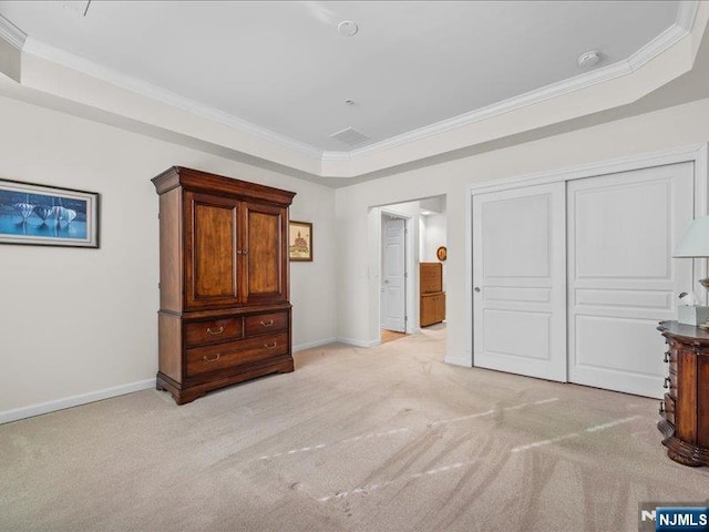 bedroom featuring ornamental molding, light carpet, and a closet