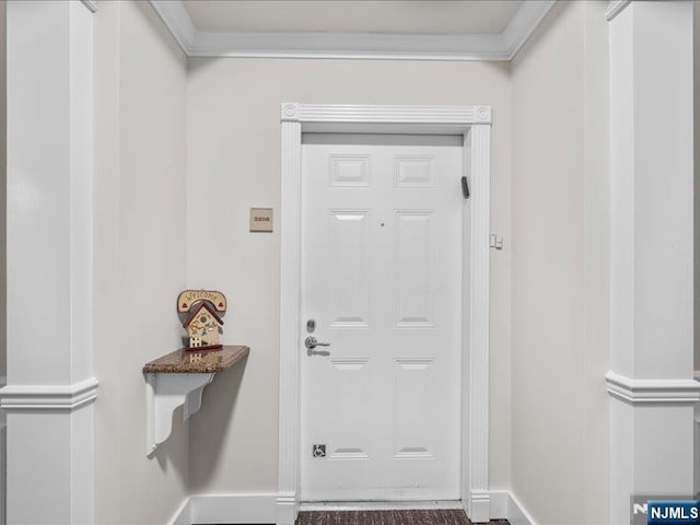 entryway featuring ornamental molding and decorative columns