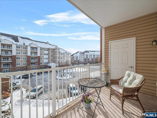 view of snow covered back of property