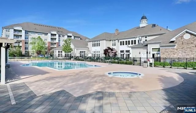 view of pool with a community hot tub and a patio