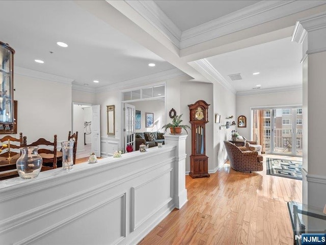 interior space with crown molding and light hardwood / wood-style flooring