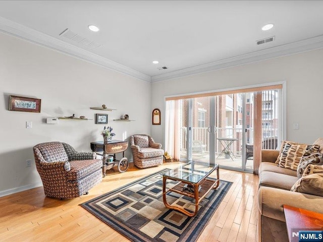 living room featuring crown molding and hardwood / wood-style floors