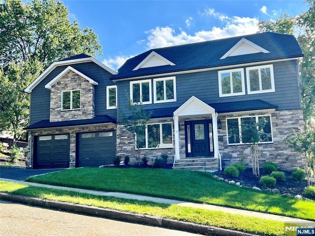 view of front facade featuring a garage and a front lawn