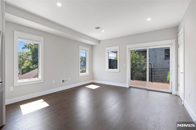 spare room featuring dark hardwood / wood-style floors