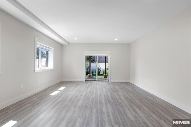 spare room with light hardwood / wood-style flooring