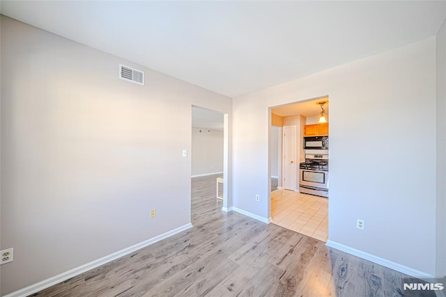 spare room with light hardwood / wood-style floors