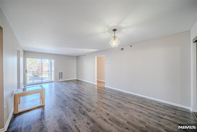 empty room with dark wood-type flooring