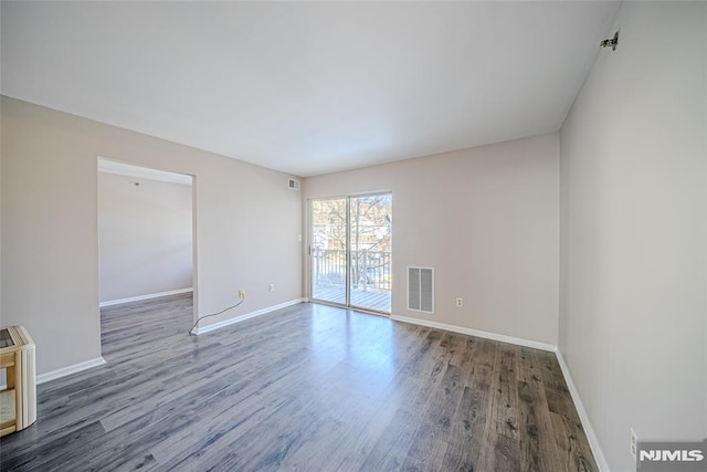 spare room featuring dark hardwood / wood-style flooring