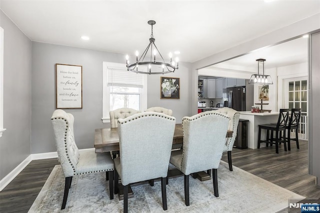 dining room featuring dark hardwood / wood-style flooring and a notable chandelier