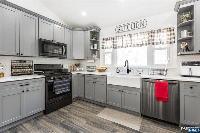 kitchen featuring appliances with stainless steel finishes, sink, and gray cabinetry