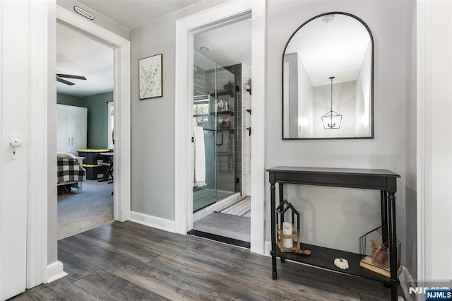 bathroom featuring a shower with door and wood-type flooring