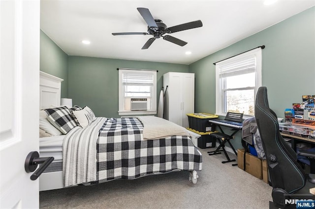 bedroom featuring multiple windows, cooling unit, carpet floors, and ceiling fan