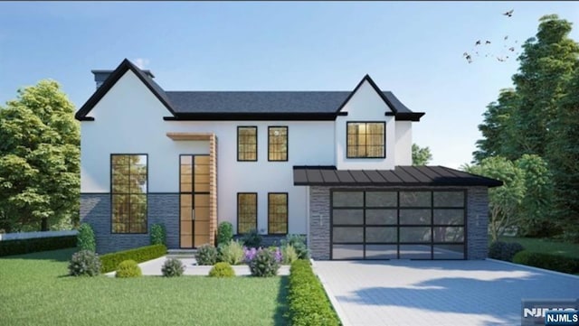 view of front of home featuring a garage and a front yard