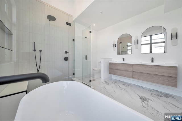 full bathroom featuring vanity, toilet, and separate shower and tub