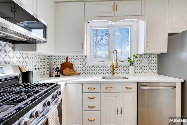 kitchen with white cabinetry, sink, backsplash, and stainless steel appliances