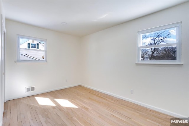 spare room featuring light hardwood / wood-style flooring