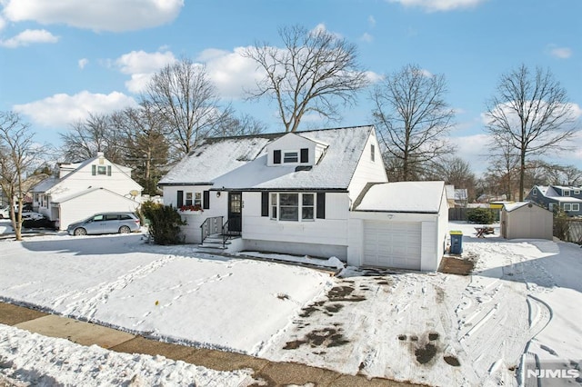 new england style home featuring a garage and a storage unit