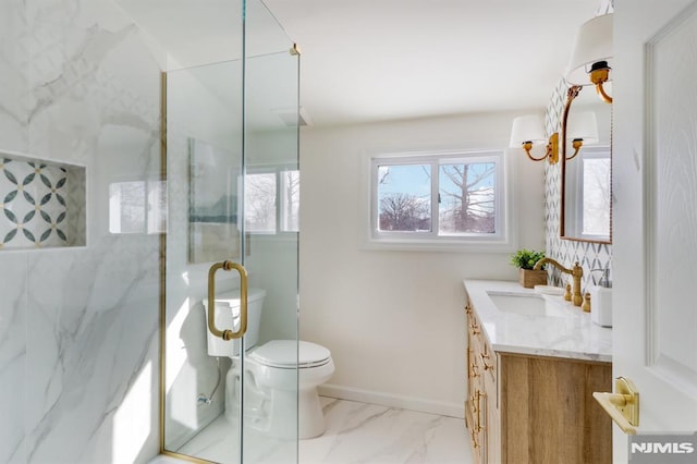 bathroom with vanity, toilet, and a shower with door