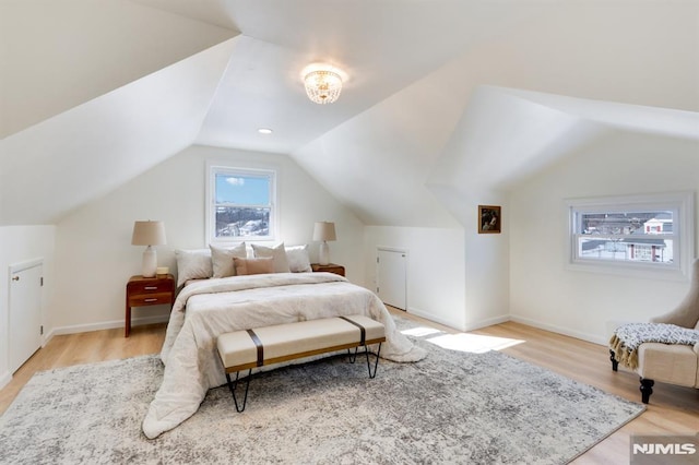 bedroom featuring vaulted ceiling and light wood-type flooring