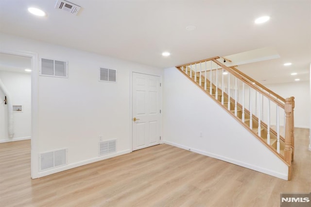 basement with light hardwood / wood-style floors