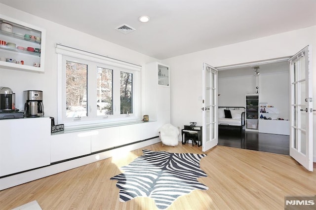 living area featuring french doors and hardwood / wood-style flooring