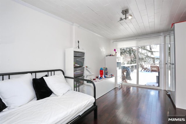 interior space with wood ceiling, ornamental molding, and dark hardwood / wood-style flooring