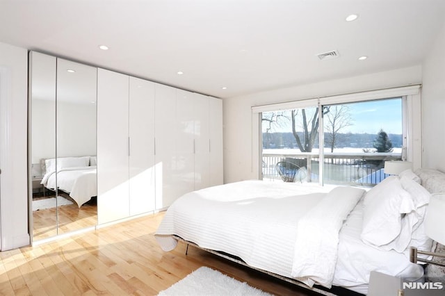 bedroom with access to exterior and light wood-type flooring