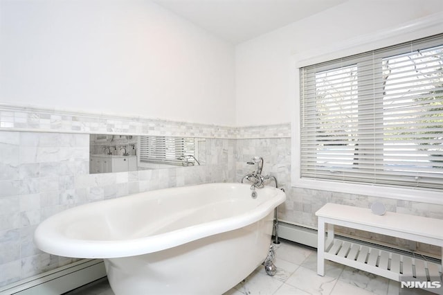 bathroom featuring tile walls, a baseboard heating unit, and a bathing tub