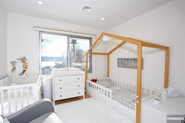 bedroom featuring lofted ceiling and a crib