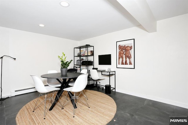 dining room with a baseboard heating unit and beamed ceiling