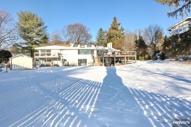 snow covered property featuring a deck