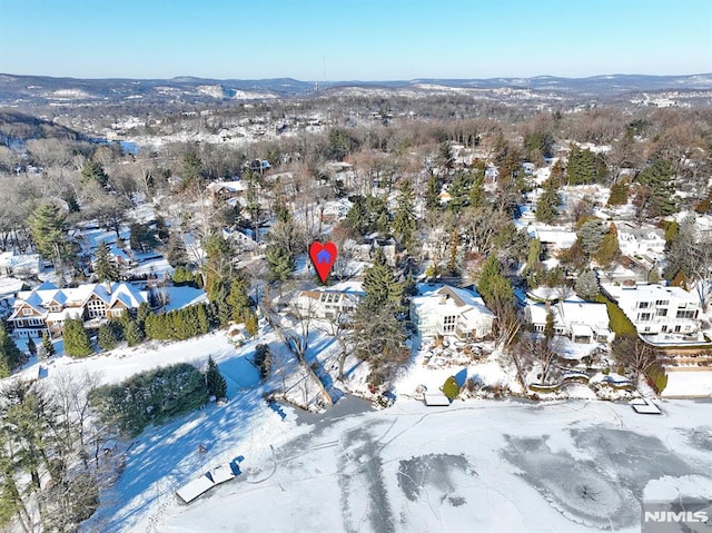 snowy aerial view featuring a mountain view